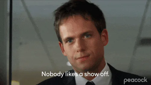 A young man in a suit says 'Nobody likes a show off.'