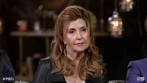 oct29-mafs-yes.gif A woman with long auburn hair on a TV panel nods yes.