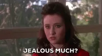 2a31c2b5-4742-a938-4e3d-d79d8a636fec.gif A young woman in a red vintage dress looks unimpressed and says 'Jealous much?'