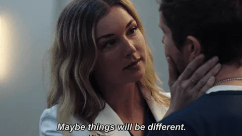 A blonde woman touches a man's cheek and says 'Maybe things will be different.'