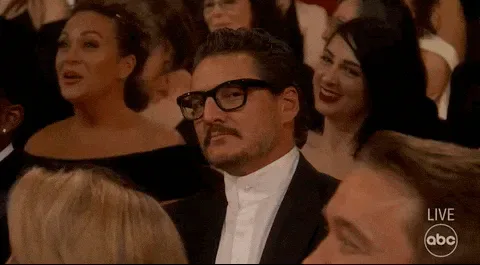 Watching+You+Pedro+Pascal+GIF+by+The+Academy+Awards.gif A man in glasses reacts with a startled expression in a crowd, with LIVE and ABC shown.