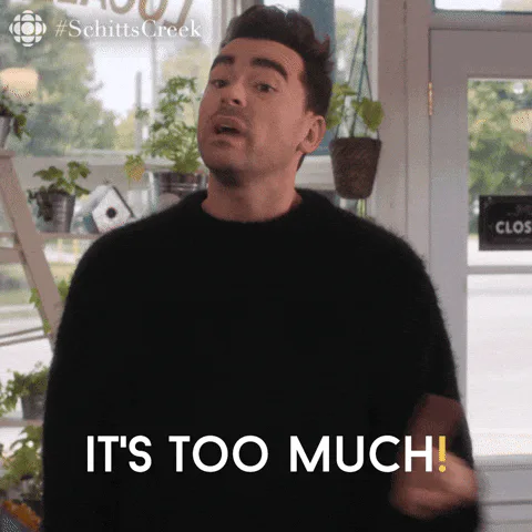 A man on Schitt's Creek says 'It's too much!' while gesturing with his hands.