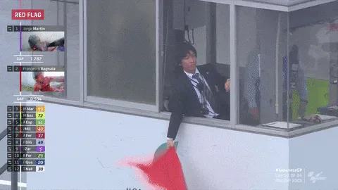 Red+Flag+Japan+GIF+by+MotoGP™.gif A race official leans from a booth waving a red flag as text reads 'Race red-flagged due to weather conditions.'