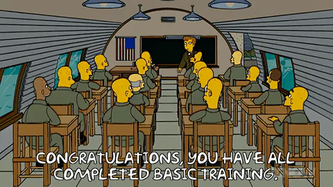 Animated soldiers sit in a classroom as an instructor says 'Congratulations, you have all completed basic training.'
