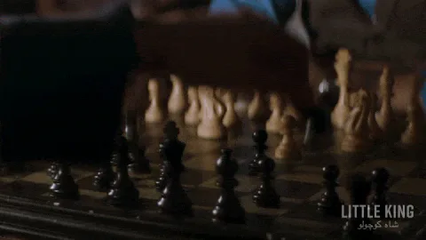 playing+games+play+GIF+by+AT&T+Hello+Lab.gif Two hands move wooden chess pieces across a board in close-up.