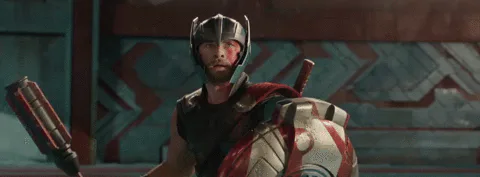 A costumed warrior shouts as the word 'Sex' flashes on screen behind him.