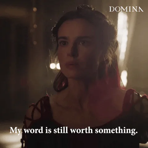 A woman in a dark red dress in a dimly lit room says, 'My word is still worth something.'