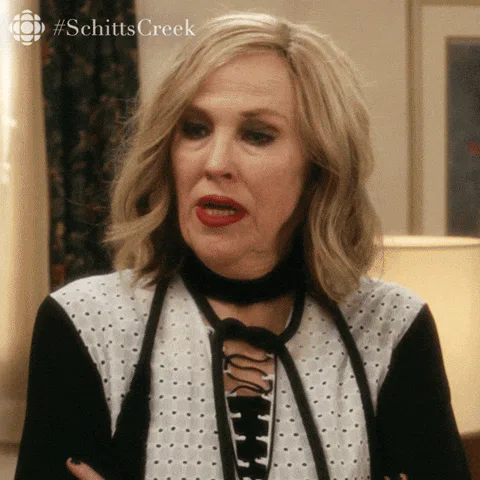 A blond woman in a floral top talks and says 'Lowering your standards is a slippery slope.'