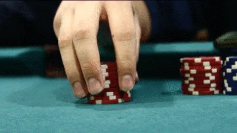 Card+Game+Poker+GIF.gif A close-up of hands stacking and restacking red poker chips on a green felt table.