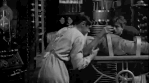 its+alive+frankenstein+GIF.gif A man in a lab coat throws his arms wide before humming machinery as text reads 'It's alive!'