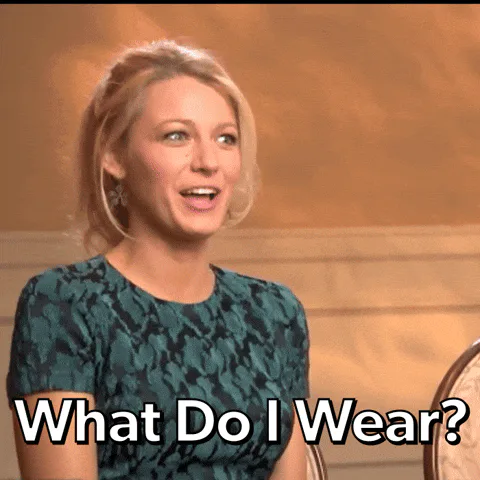 A blonde woman in a teal dress looks surprised and exclaims 'What do I wear?'