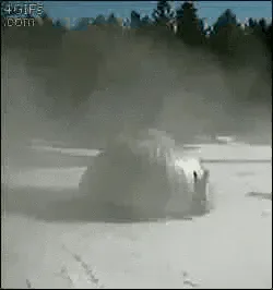 erection+GIF.gif A grain silo in a snowy field leans and slowly topples near a red building, ending captioned 'Boing.'