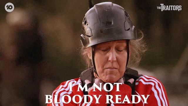 A woman in a red jacket and metal helmet smiles as on-screen text reads 'I'm not bloody ready.'