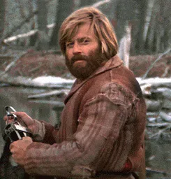 Happy+If+You+Say+So+GIF.gif A bearded man with long blond hair in a fur coat nods slowly in a snowy forest.